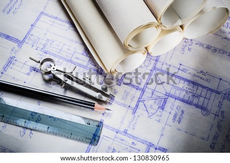 blueprints and drafting tools on a desk