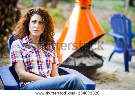 attractive young woman sitting outside