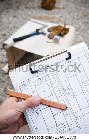 worker holding construction blue prints