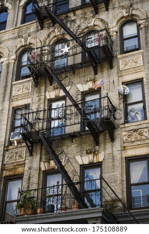 fire escapes on an apartment building in a large city