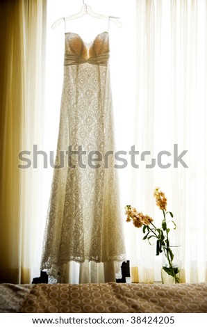 stock photo Wedding dress hanging in window