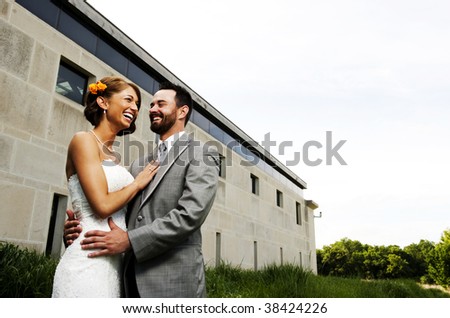 Attractive young couple in formal wear laughing