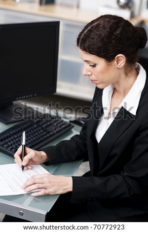businesswoman doing paperwork in an office
