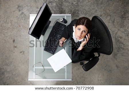 overhead view of a business woman on the phone in an office