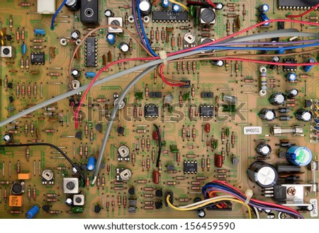 Top view of a circuit board with electrical components and colored cords