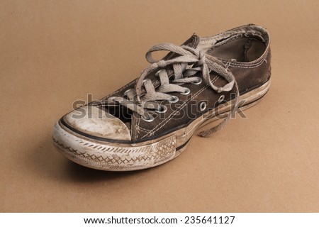 Old dirty brown shoe on brown background