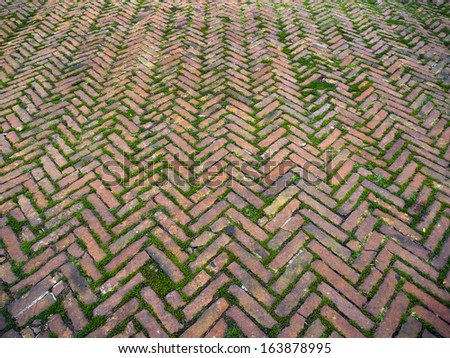medieval herringbone pattern brickwall detail shot in Tuscany, known to Romans as opus spicatum and widely used in medieval times too.
