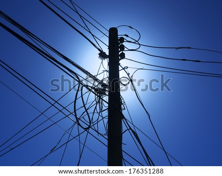 Telephone pole with power lines in third world country