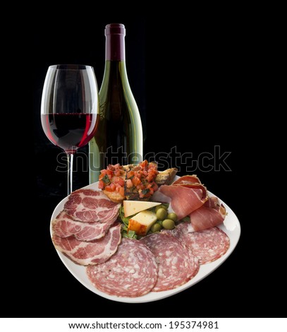 Italian antipasto with ham, olive, tomato, cheese, bread,  salami and a lovely Chianti red wine