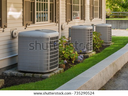 Heating and air conditioning inverters on the side of a condo