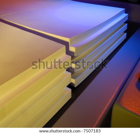 Stacked paper coming out of a cutting machine