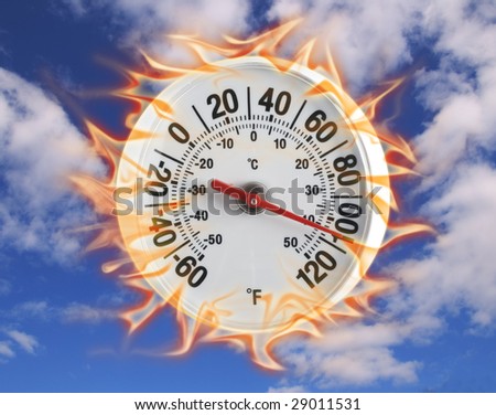 Thermometer on fire with blue sky