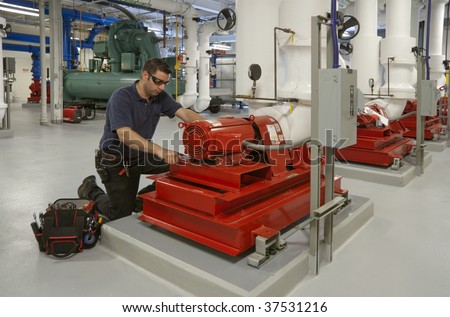 workman repairing electric motor in building transformer underground