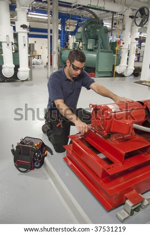 workman repairing electric motor in building transformer underground