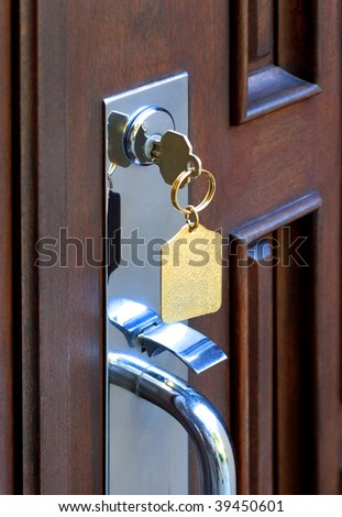 House key in door lock of contemporary house
