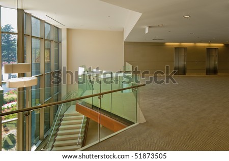 Balcony overlooking modern glass lobby in office building