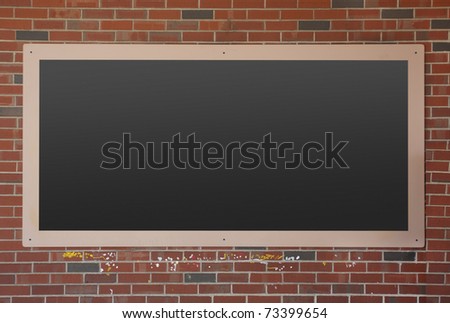 Empty blackboard on brick wall