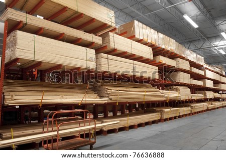 Wood stacked on shelving inside a lumber yard