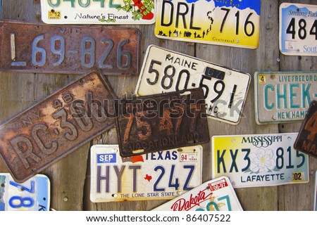 Collection of old vintage American license plates on a wood wall