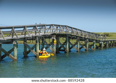 Kayaking under the foot bridge to get to the ocean