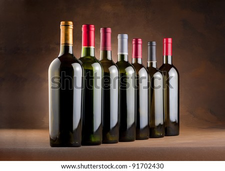 Red wine bottles lined up in a row