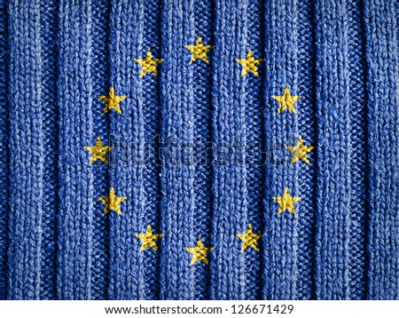 Close-up view of wool fabric pattern with the flag and emblem of Europe. European Union background.