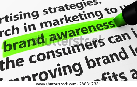 Marketing and advertising concept with a 3d rendering of brand developing strategies related words and brand awareness text highlighted with a green marker.