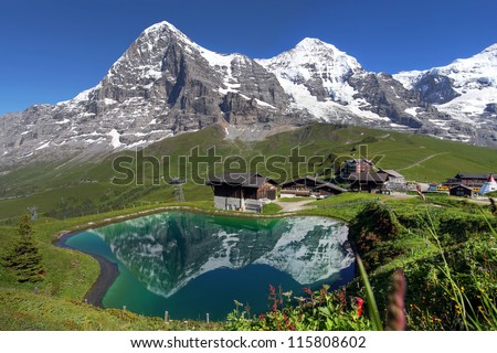 Landscape with Eiger, Moench and part of Jungfrau (to the right), in the Swiss Alps (Bernese Alps) reflecting in a pond at Kleine Scheidegg.