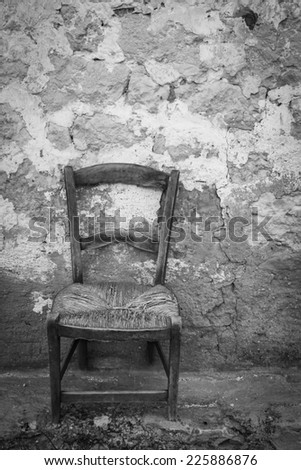 Outdoor shot of an old chair in black and white.