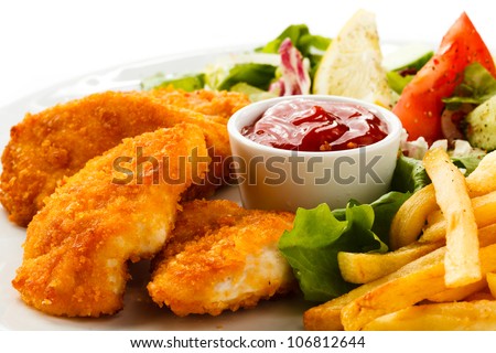  Fried chicken nuggets, French fries and vegetables - stock photo