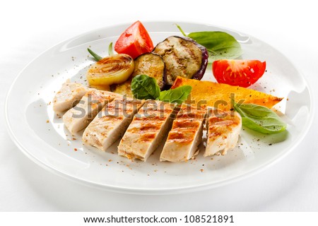 Grilled turkey fillet with vegetables on white background