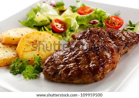 Grilled beefsteak, baked potatoes and vegetables