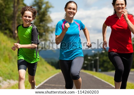 Active family - mother and kids running outdoor