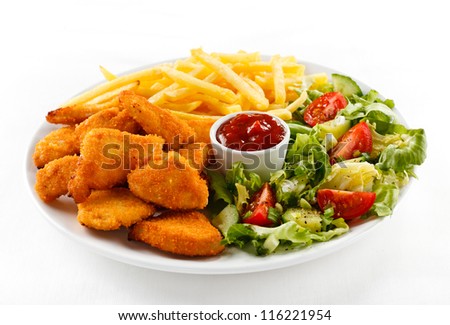 Fried chicken nuggets French fries and vegetables Fried chicken nuggets French fries and vegetables