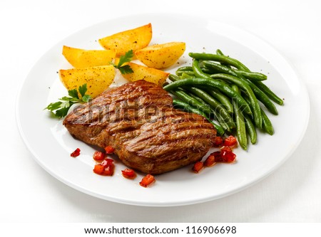 Grilled steaks, baked potatoes and vegetables