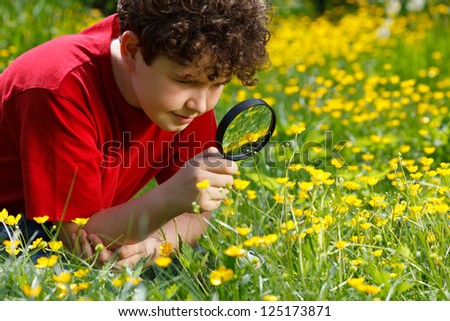 Boy looking through magnifying glass