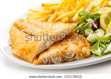 Fish dish - fried fish fillet, French fries with vegetables