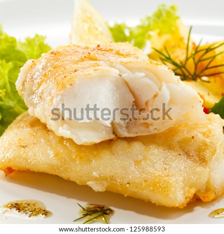 Fish dish - fried fish, fried potatoes and vegetables