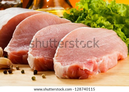 Raw Pork On Cutting Board And Vegetables