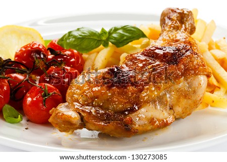 Grilled chicken leg, French fries and vegetables