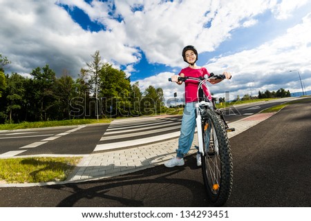 Girl biking on cycle lane