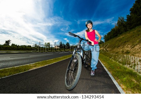 Girl biking on cycle lane