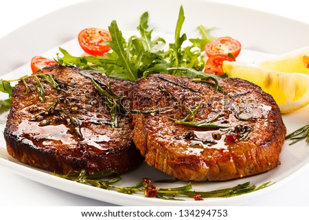 Grilled steaks and vegetable salad