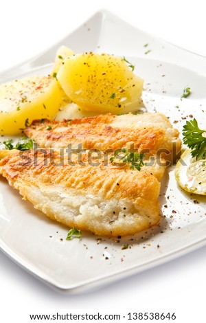 Fish dish - fried fish fillets, boiled potatoes and vegetable salad