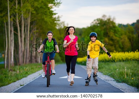 Active Family - Mother And Kids Running, Biking, Rollerblading