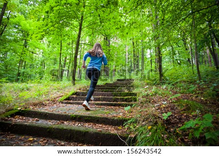 Healthy lifestyle - girl running, jumping in park