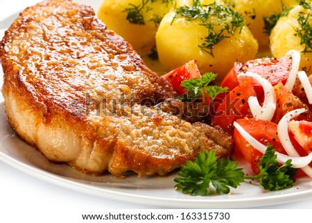 Pork chop, boiled potatoes and vegetables