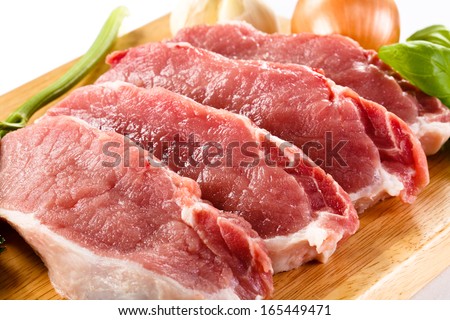 Fresh raw pork chops on white background