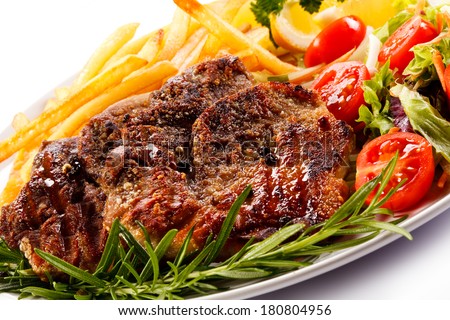 Grilled steak, chips and vegetables