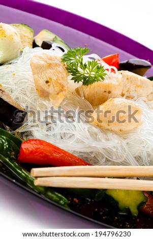 Roasted meat, rice noodles and vegetables on white background